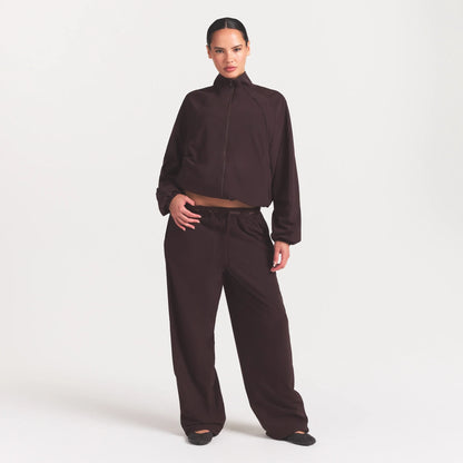 NikeSKIMS STRETCH NYLON OVERSIZED TRACK JACKET | DARK ROAST