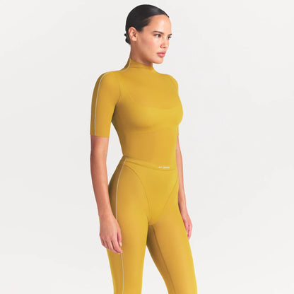 NikeSKIMS WEIGHTLESS LAYERS MOCK NECK SHORT SLEEVE T-SHIRT | CITRINE