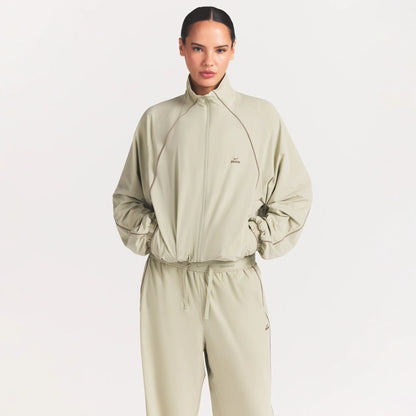 NikeSKIMS STRETCH NYLON OVERSIZED TRACK JACKET | TALC