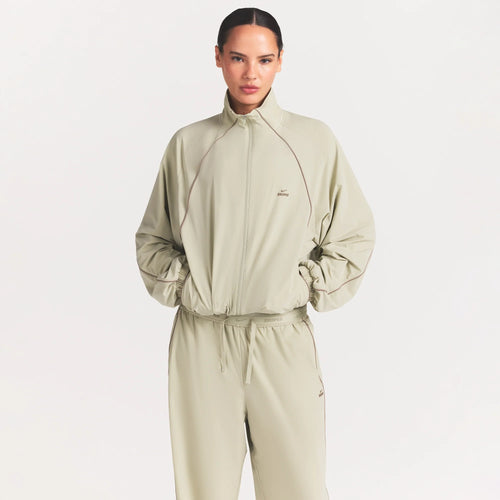 NikeSKIMS STRETCH NYLON OVERSIZED TRACK JACKET | TALC