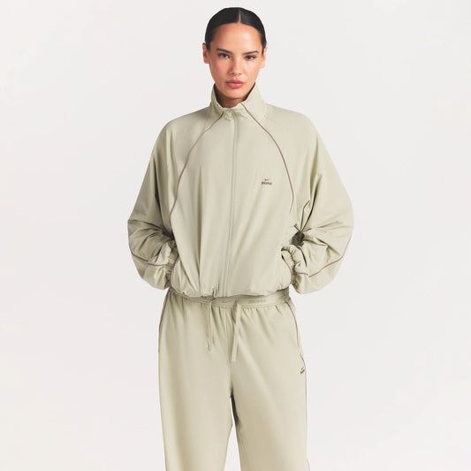 NikeSKIMS STRETCH NYLON OVERSIZED TRACK JACKET | TALC